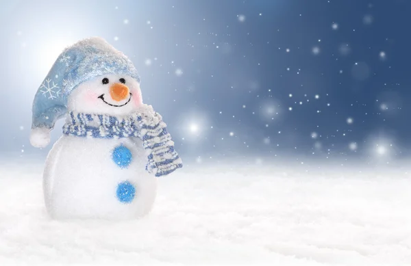 Holiday or winter background with a cute, cheerful snowman in snow