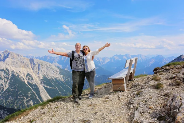 Hiking - couple standing on mountain summit in the Bavarian Alps