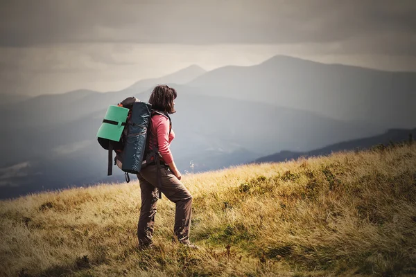 Young woman hiking on mountains with backpack Travel Lifestyle a