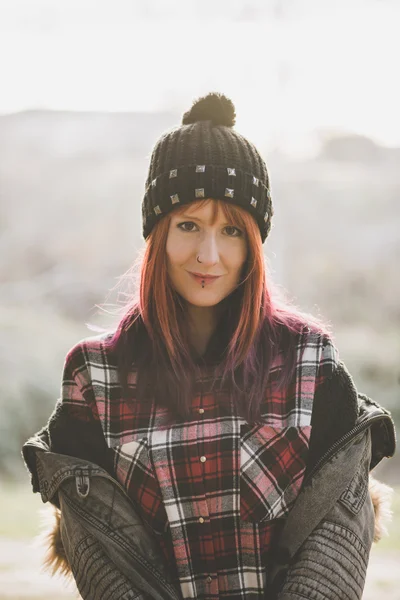 Portrait of red-haired girl in hat