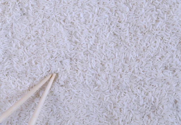 Close-up of white rice and wooden sticks