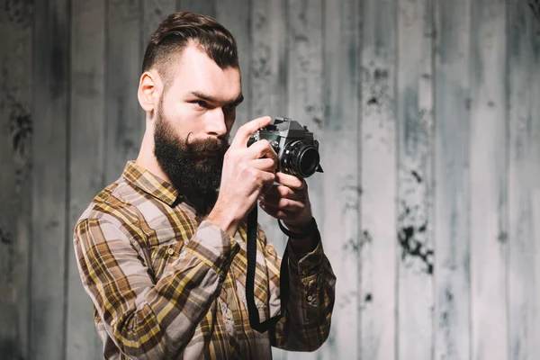 Hipster takes photo with vintage film camera