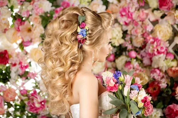 Wedding hairstyle a young girl. Bride. Woman with Flowers in her