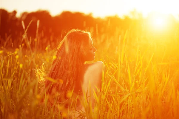 Young hipster model woman Casual Girl in field in Sunset in spri