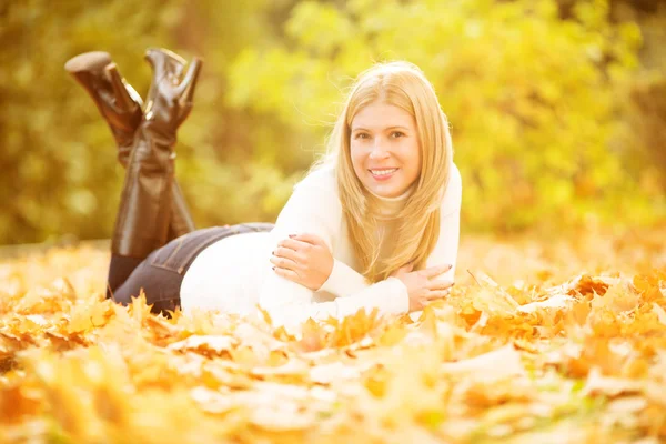 Autumn woman on background fall landscape leaves of trees. Model