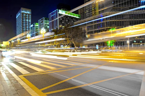 High speed and blurred bus light trails in downtown nightscape
