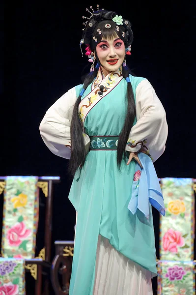 Pretty chinese opera actress perform on stage with traditional costume.