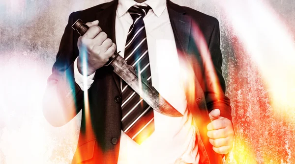 Business competition,Businessman bring out knife ready to fight or protect business.