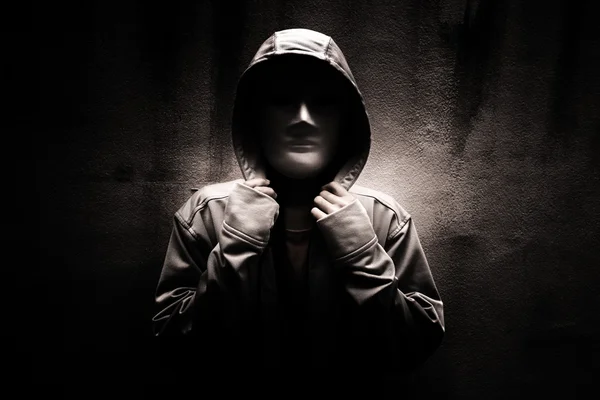 Dark doctrine,Mysterious woman wearing white mask under hoodie,Scary background for book cover