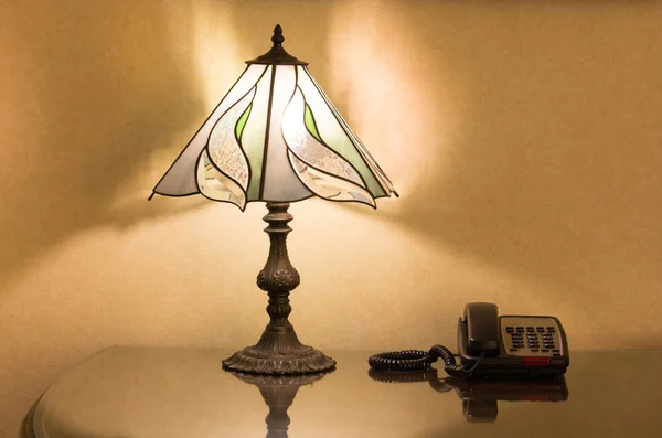 Table lamp and phone on desk