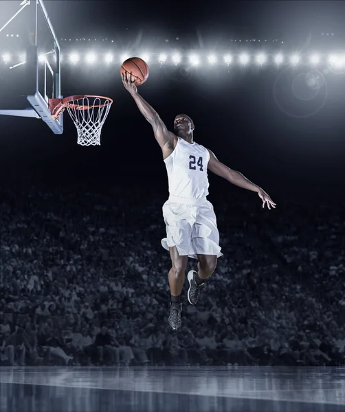 Athletic African American Basketball Player scoring a basket