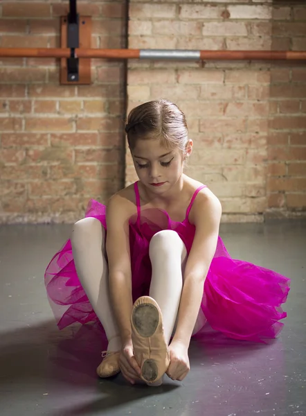 Beautiful young ballerina getting ready for class