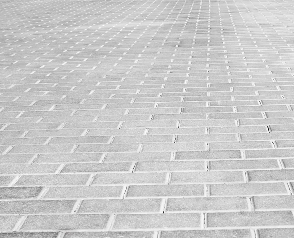 Grey brick stone street road. Light sidewalk, pavement texture