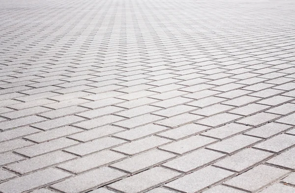 Grey brick stone street road. Light sidewalk, pavement texture