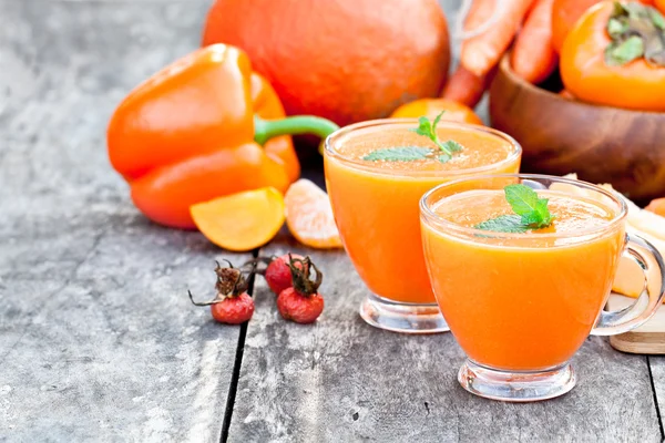 Fresh  healthy pulpy cocktail with orange fruits and berries and