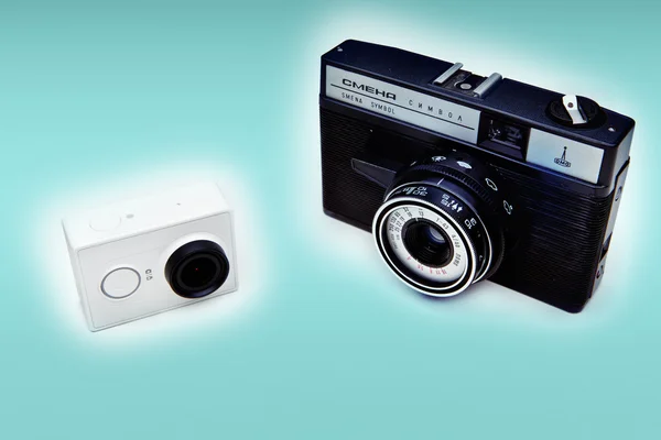 White action camera and old camera