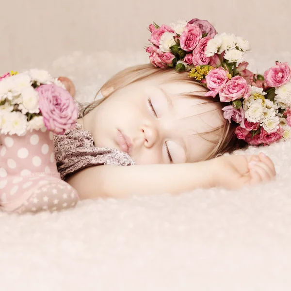 Sleeping baby girl in flowers