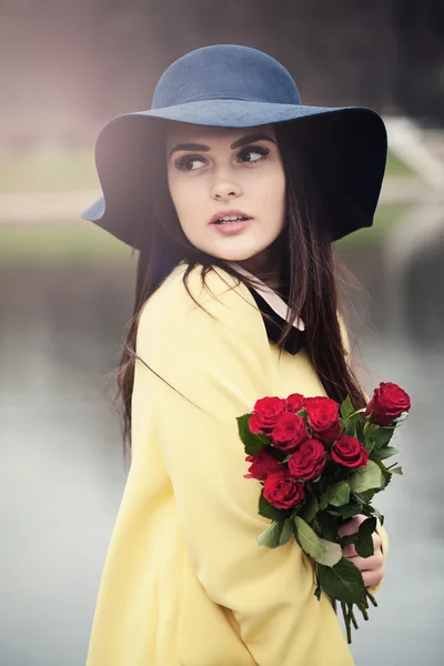 Beautiful Lady with Red Roses Flowers Outdoors