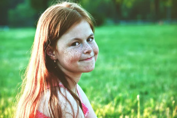 Smiling redhead girl with freckles