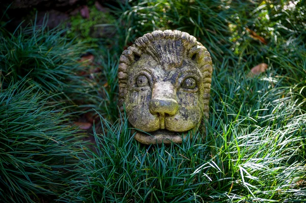 Lion face sculpture in the Monte touristic garden of Funchal.