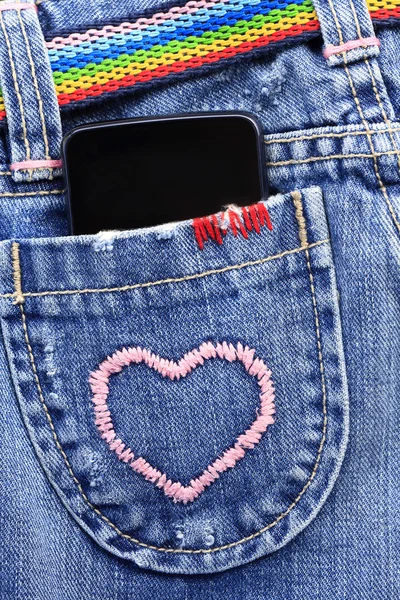 Smart phone in the pocket of jeans