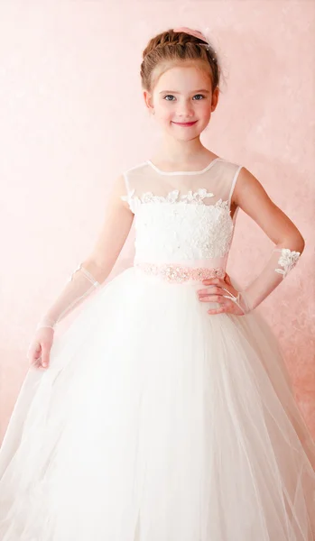 Adorable smiling little girl in white princess dress