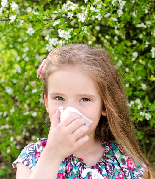 Little girl has allergy to spring blossoming