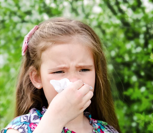 Little girl has allergy to spring blossoming