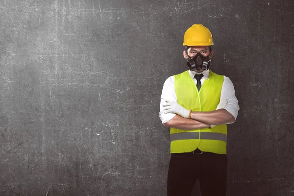 Worker wearing safety vest and helmet