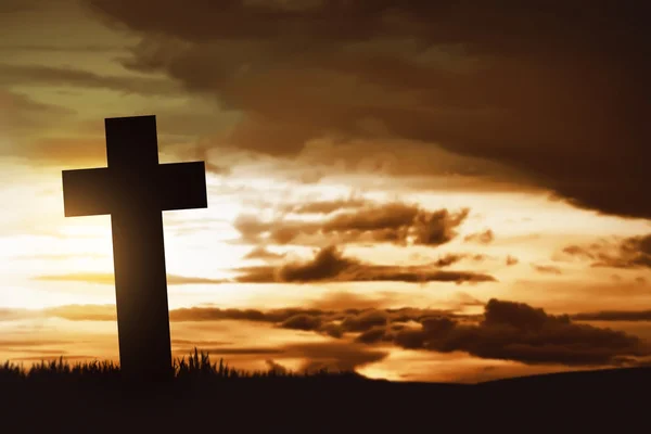 Wooden christian cross at sunset