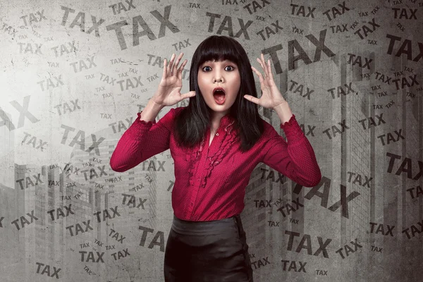 Business woman shocked looking the tax