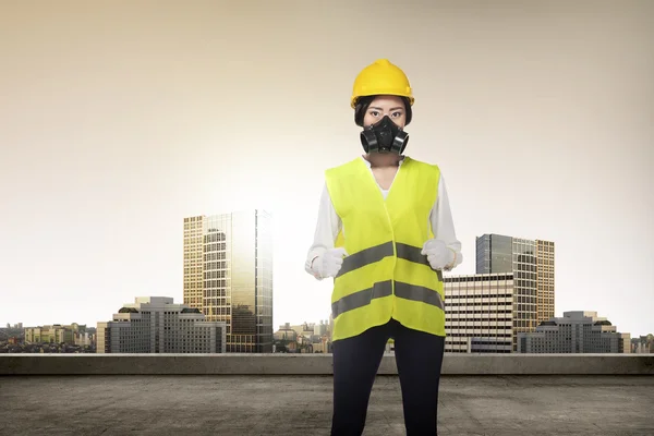 Asian woman in safety vest posing