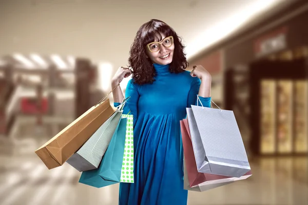 Asian woman holding shopping bags