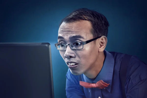 Nerd man concentration using laptop