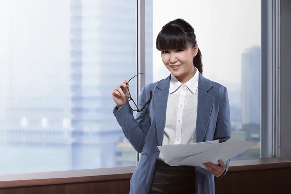 business woman holding papers