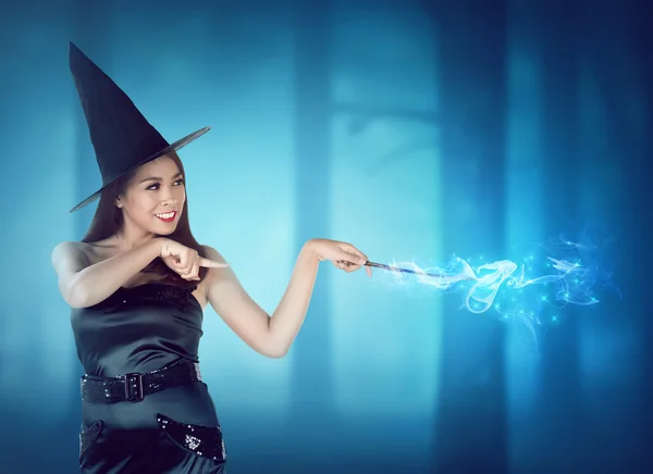 Young asian witch with magic wand
