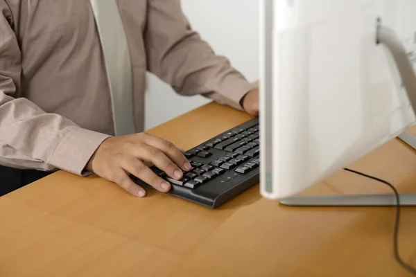 Business man typing with keyboard
