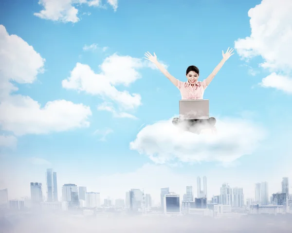 Business woman working on the cloud above the city