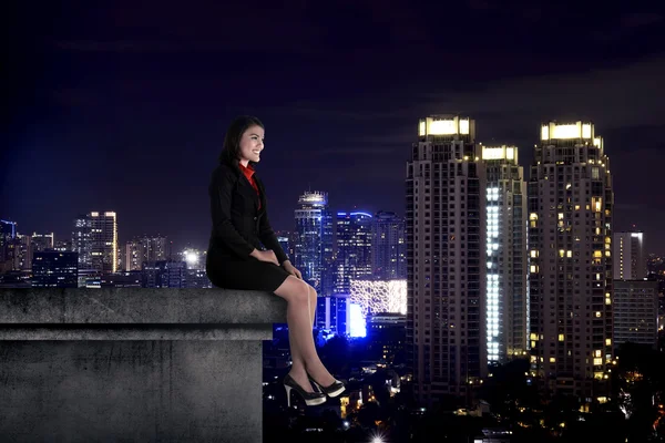 Business woman sit on the building rooftop