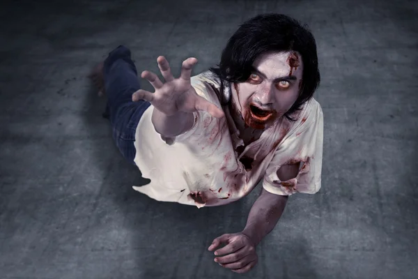 Male zombie crouching on the floor