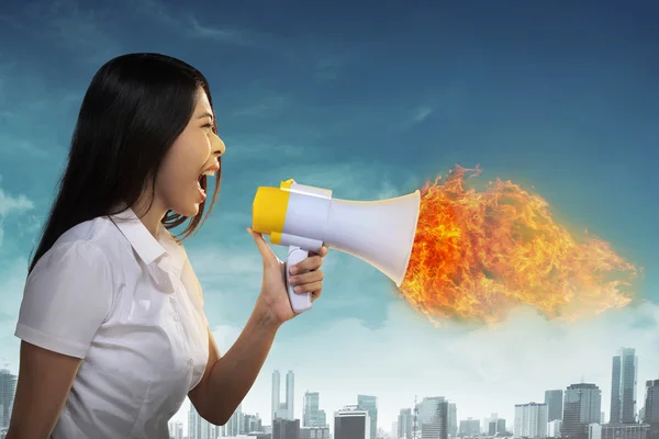 Asian businesswoman with a megaphone shouting