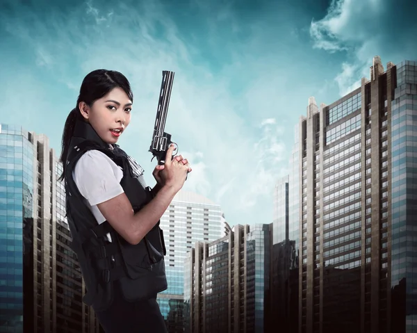 Beautiful police woman holding gun