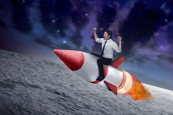 Asian businessman flying ride rocket