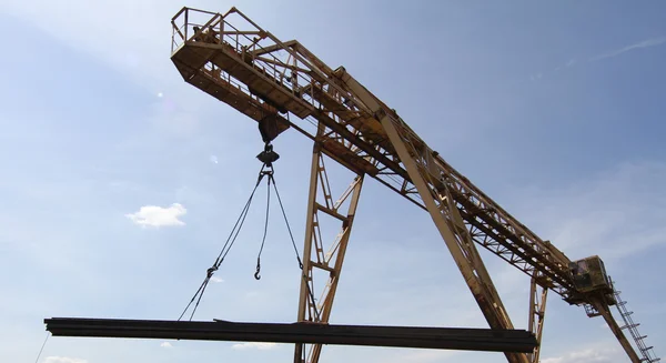 Gantry crane lifts and moves a pack with metal reinforcement
