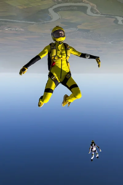 Girl parachutist performs figure freestyle