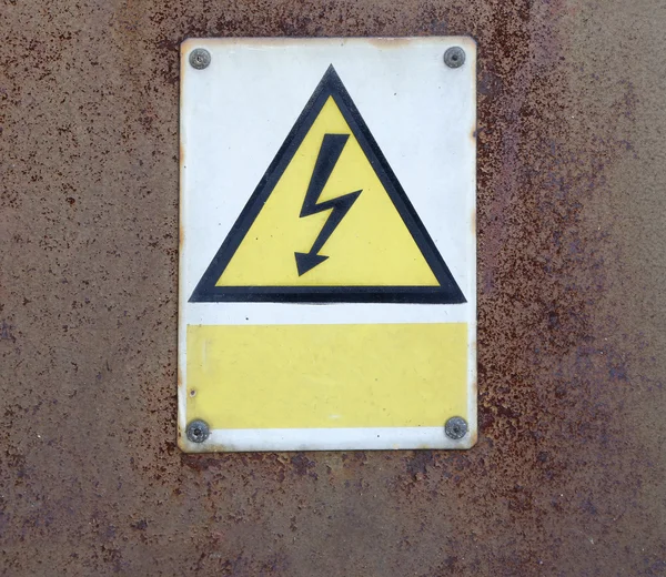 Old rusty metal wall and warning attention sign board and empty space to your own text