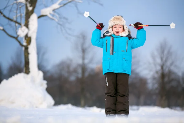 Cute little boy having fun during skiing on cross