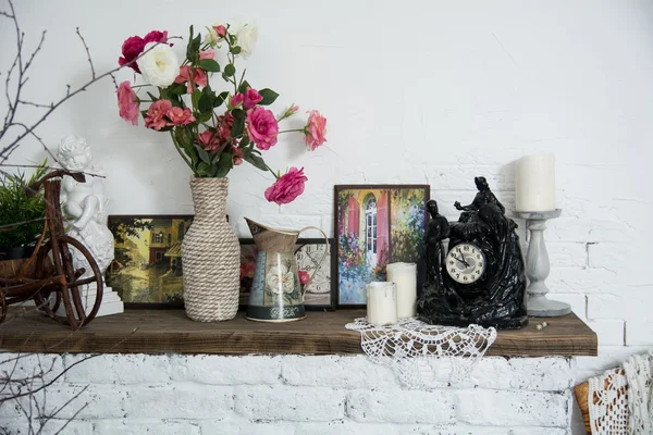 Interior design vases with flowers and candles clock brick firep