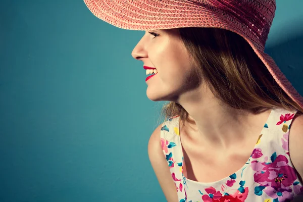 Beautiful smiling girl in a hat in profile