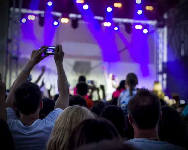 Photo of young people having fun at rock concert, active lifestyle,